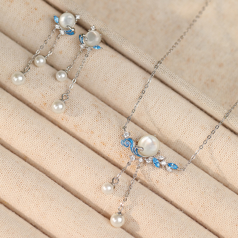 Original sunset-themed earrings for women, made of pure silver, featuring a creative new Chinese design with pearl tassels and wave-shaped embellishments