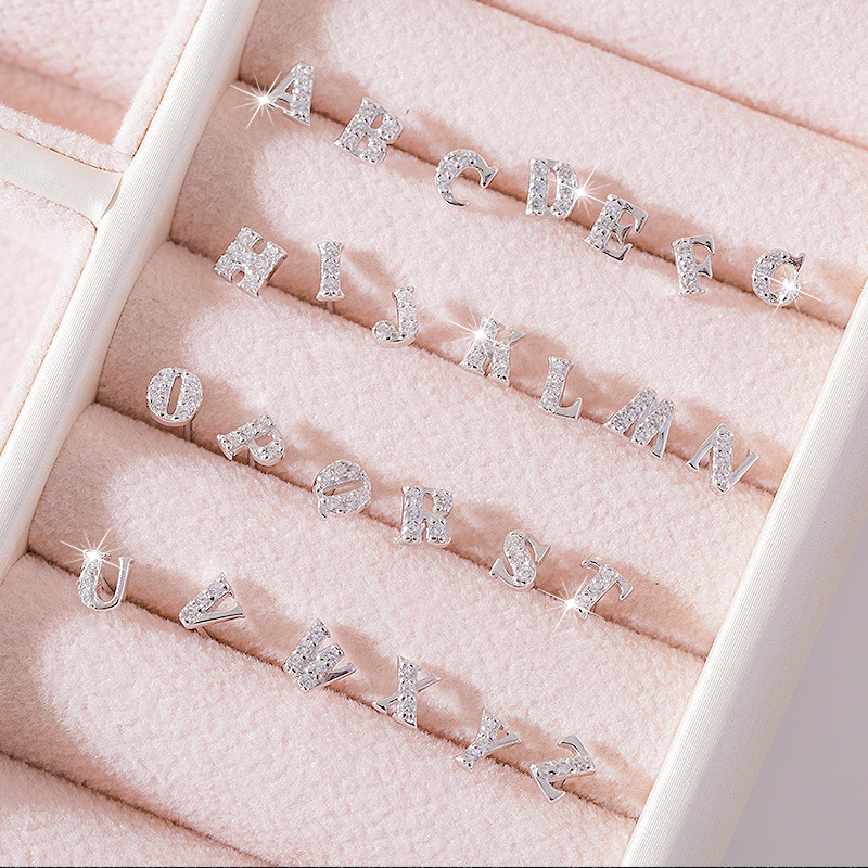 Korean-style mini and cute 925 silver earrings, featuring a feminine and stylish design, simple and minimalist, suitable for students and couples, with English letter studs, and a trendy look for men