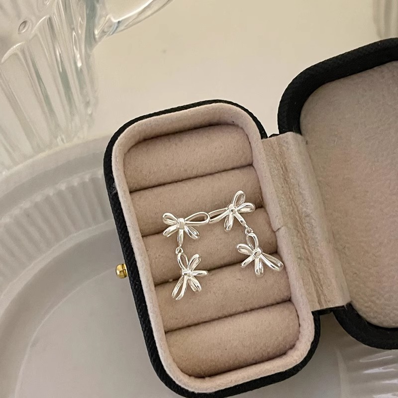 925 sterling silver double ribbon bow earrings for women, featuring a minimalist French design, a unique and sophisticated style, and tassel accents, perfect for an Instagram-inspired look
