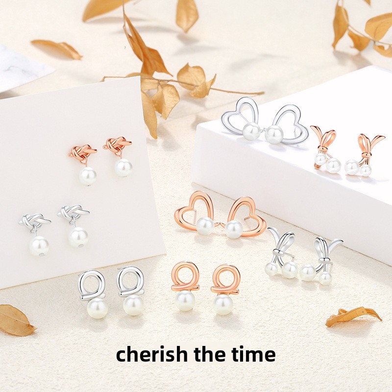 925 sterling silver bow-shaped heart earrings, French-style, chic and elegant, with pearl accents, creating a sophisticated and stylish geometric design
