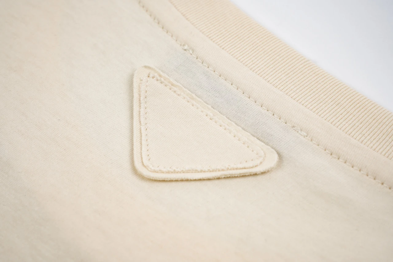 Prada Off-White Distressed Small Logo Triangle T-Shirt product photo from LabelPicks