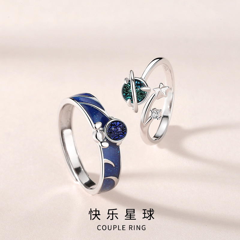 A pair of astronaut-themed couple rings, featuring a Korean-style, unique design with cosmic and starry sky cartoon characters, made of S925 sterling silver, suitable for both men and women