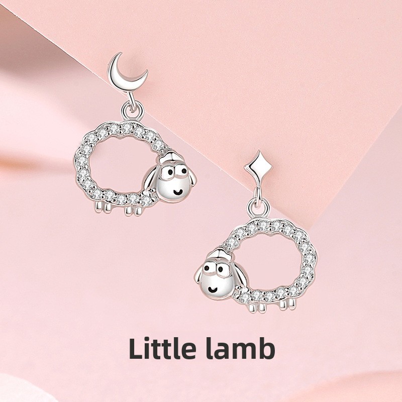 Original hollow-out lamb-shaped earrings, made of sterling silver, featuring a delicate and minimalist star and moon design, with tiny cubic zirconia accents