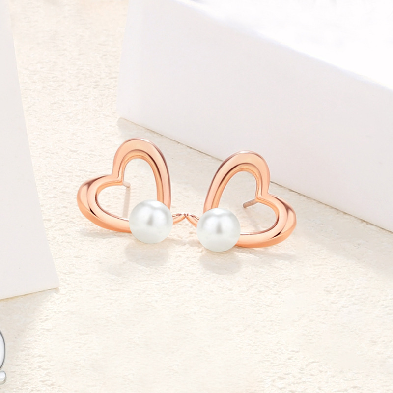 925 sterling silver bow-shaped heart earrings, French-style, chic and elegant, with pearl accents, creating a sophisticated and stylish geometric design