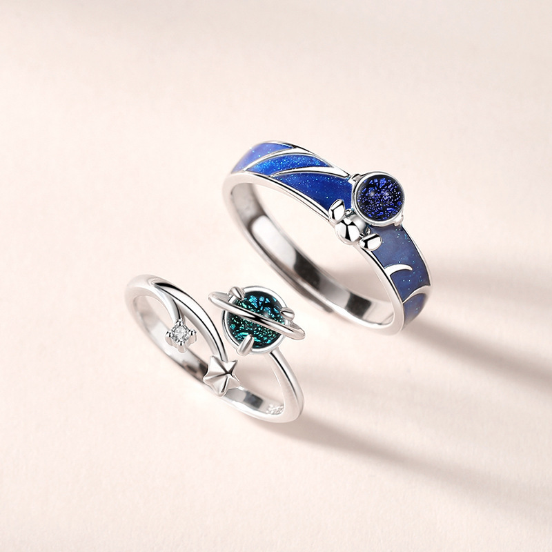 A pair of astronaut-themed couple rings, featuring a Korean-style, unique design with cosmic and starry sky cartoon characters, made of S925 sterling silver, suitable for both men and women