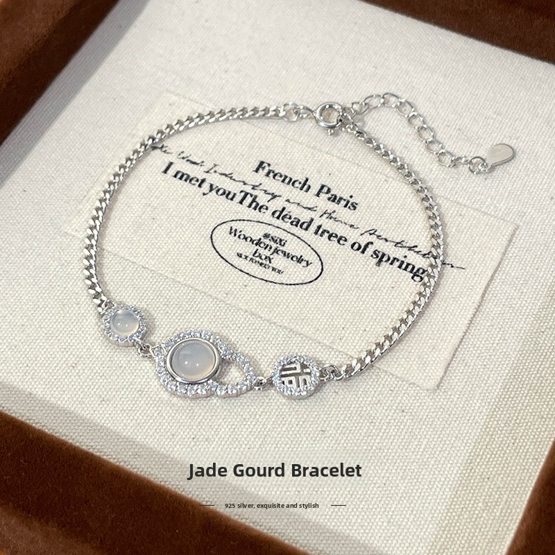 925 sterling silver bracelet with a lucky gourd charm, designed for women, exuding elegance and a retro, modern Chinese style, featuring white jade and the Chinese character for "fortune."