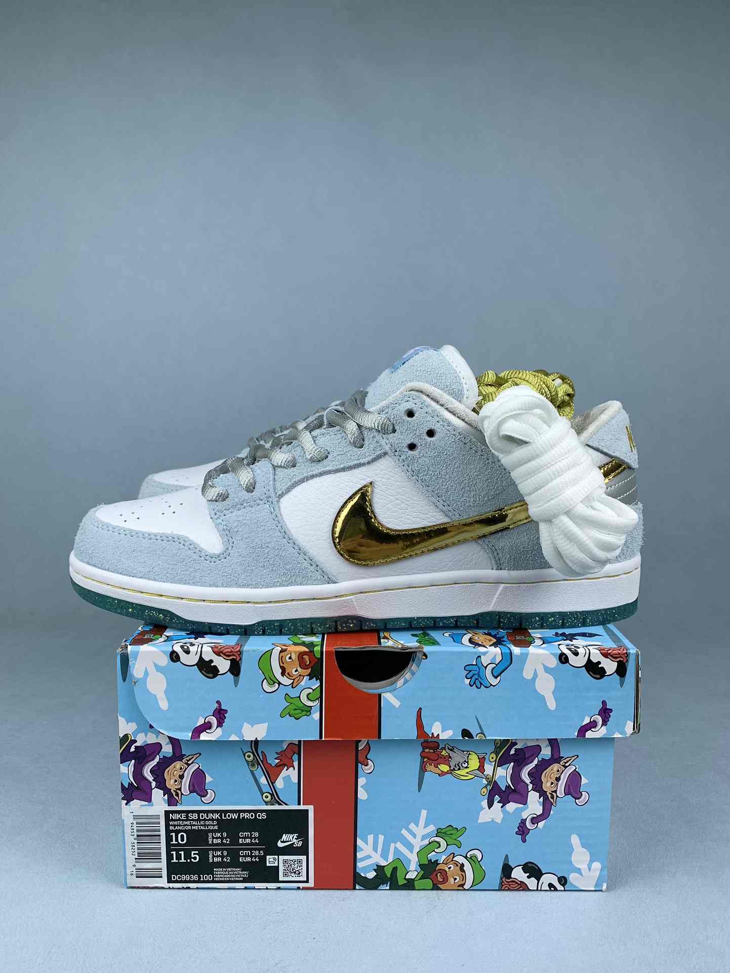 Sean Cliver x Nike SB Dunk Low Pro QS “Holiday Special” - White/Psychic Blue/Metallic Gold