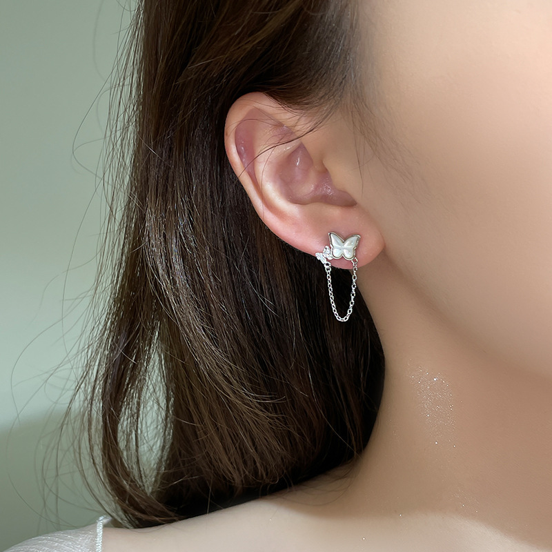 999 pure silver butterfly chain tassel earrings, Korean-style, forest-inspired, Instagram-worthy, with mother-of-pearl accents, creating a delicate and sophisticated look