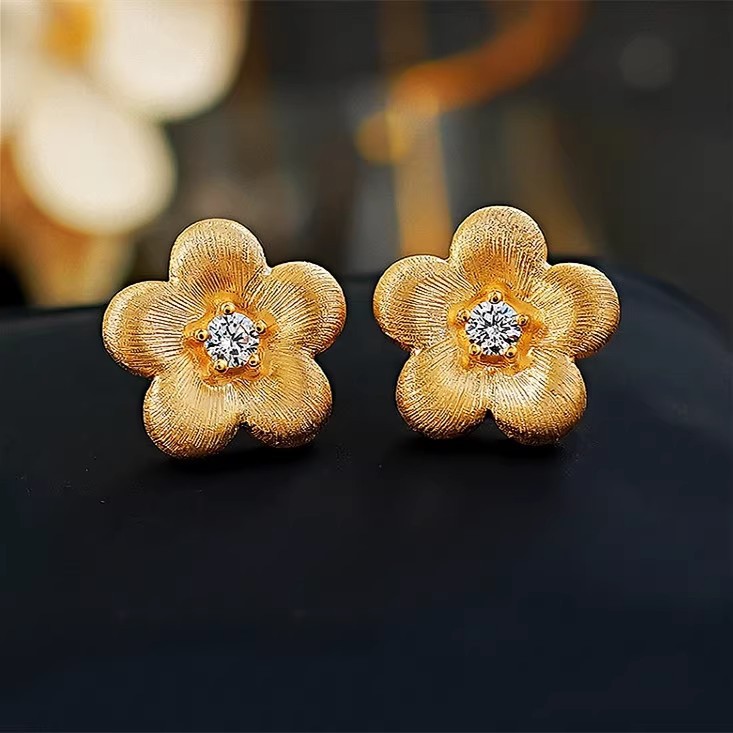 S925 sterling silver earrings with a brushed finish and small gold flower design, a delicate and luxurious summer accessory for women, featuring a unique and stylish design