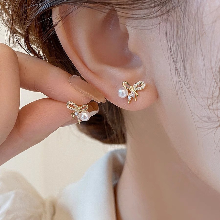S925 sterling silver bow-shaped earrings with pearl embellishments, featuring a delicate and unique design, offering a touch of luxury and versatility for any outfit
