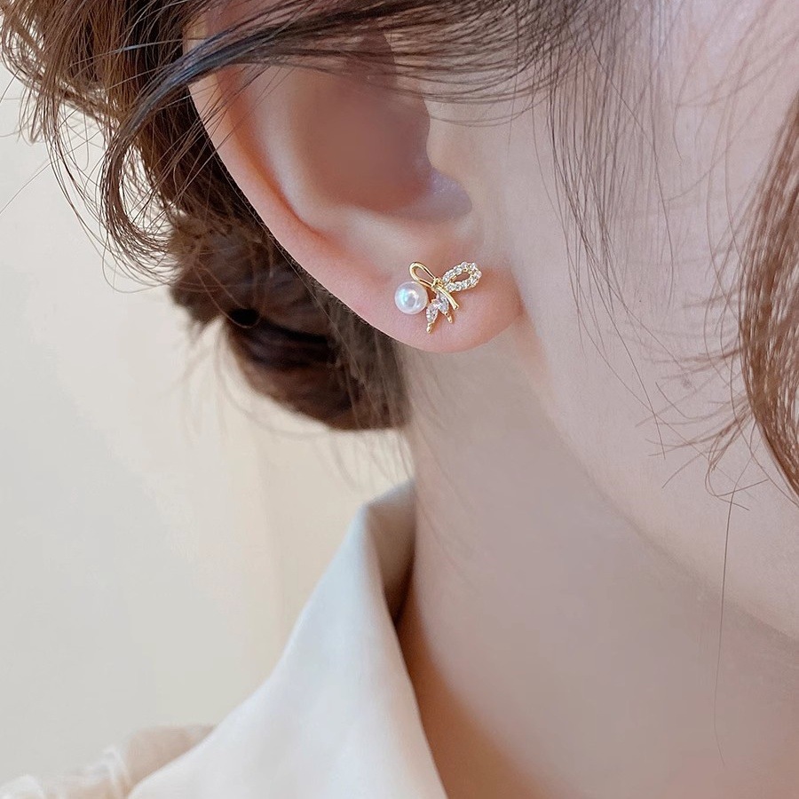 S925 sterling silver bow-shaped earrings with pearl embellishments, featuring a delicate and unique design, offering a touch of luxury and versatility for any outfit