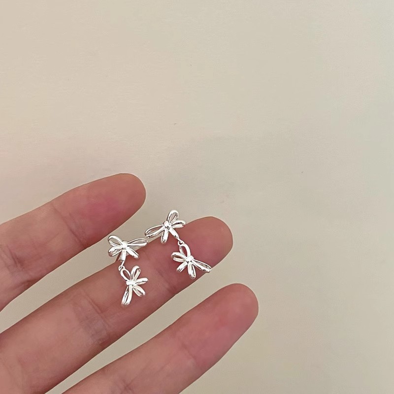 925 sterling silver double ribbon bow earrings for women, featuring a minimalist French design, a unique and sophisticated style, and tassel accents, perfect for an Instagram-inspired look
