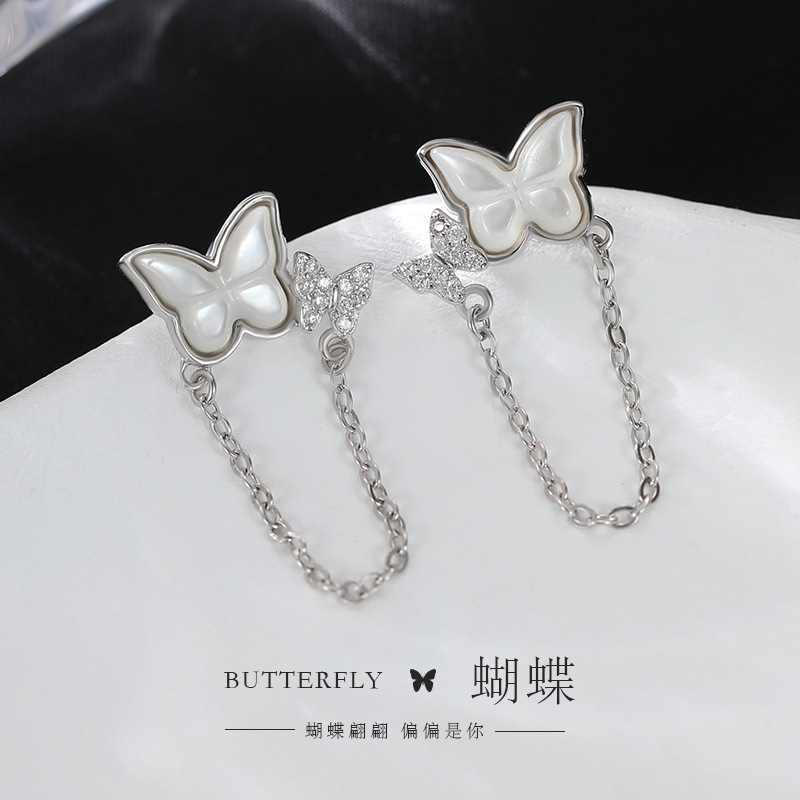 999 pure silver butterfly chain tassel earrings, Korean-style, forest-inspired, Instagram-worthy, with mother-of-pearl accents, creating a delicate and sophisticated look