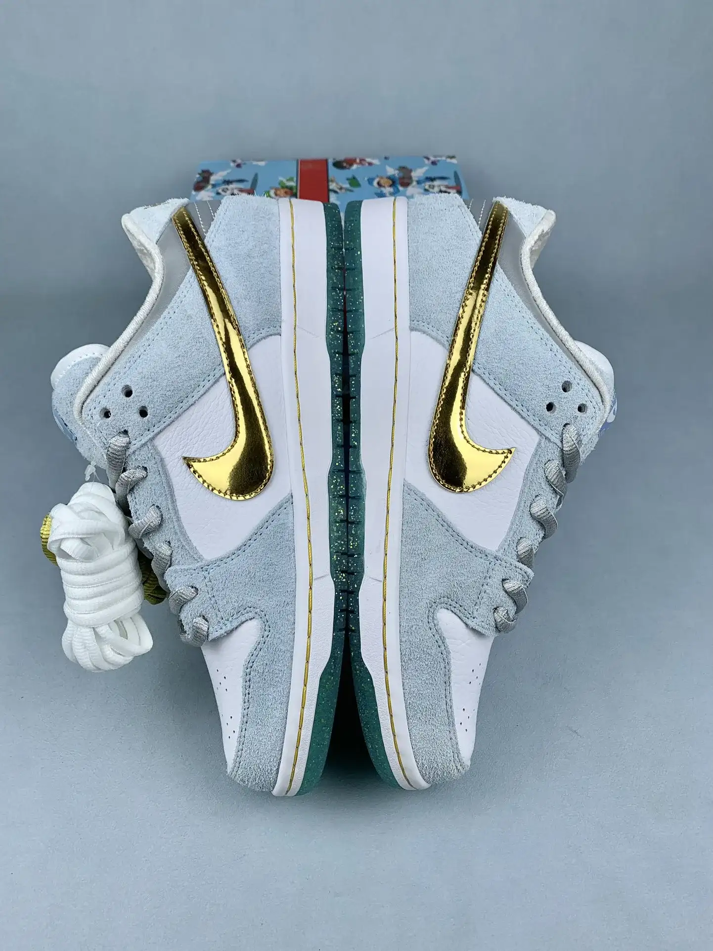 Sean Cliver x Nike SB Dunk Low Pro QS “Holiday Special” - White/Psychic Blue/Metallic Gold product photo from LabelPicks