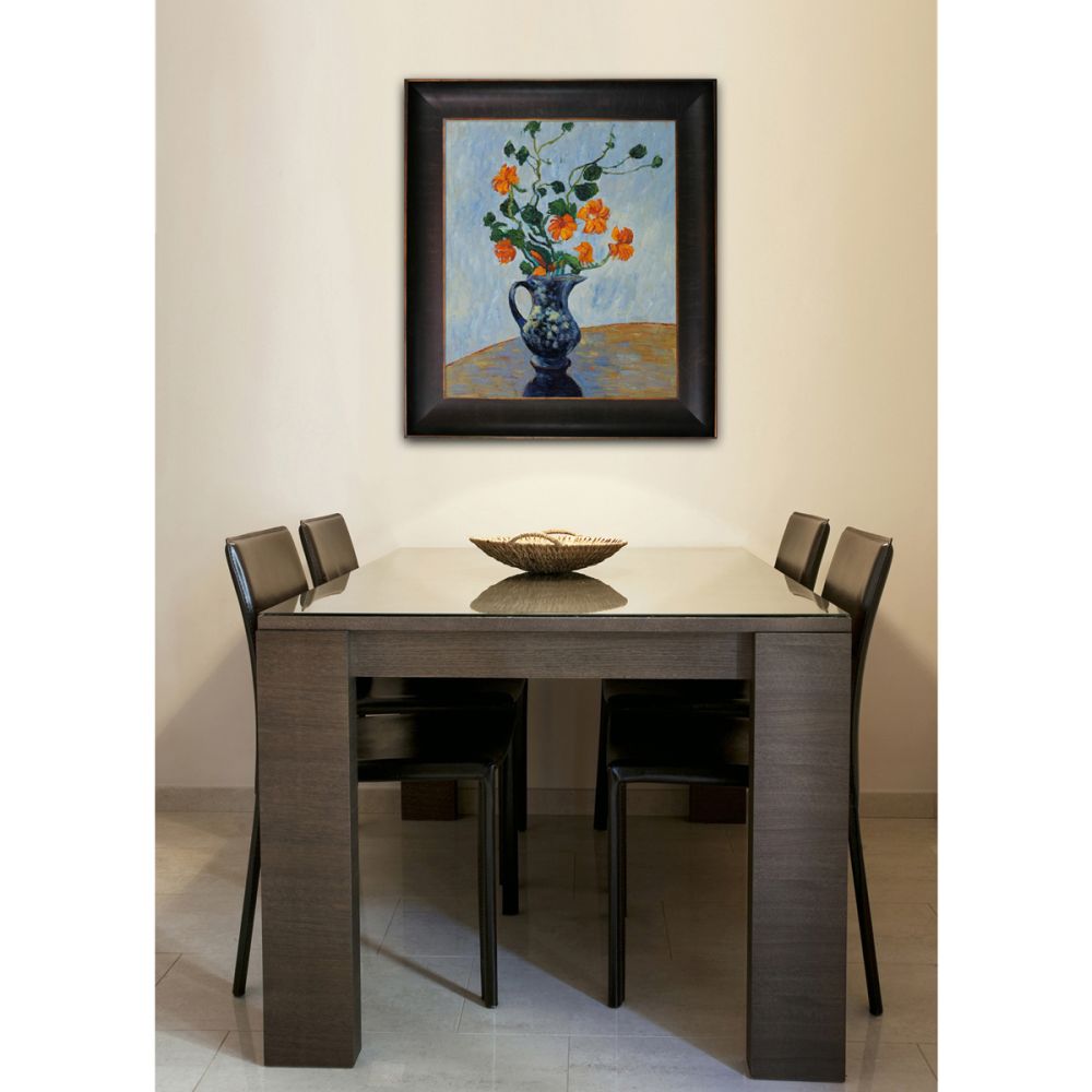 Framed floral wall art hanging in a modern dining room above a dark wood table with four chairs, minimalist home decor inspiration.