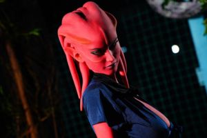 Red skin sex doll in a seductive navy blue outfit with alluring features