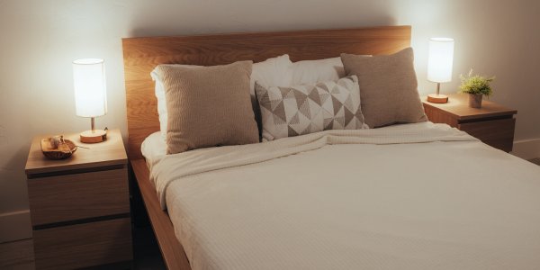 Couple demonstrating the face off sex position on a stable surface like a bed or sofa