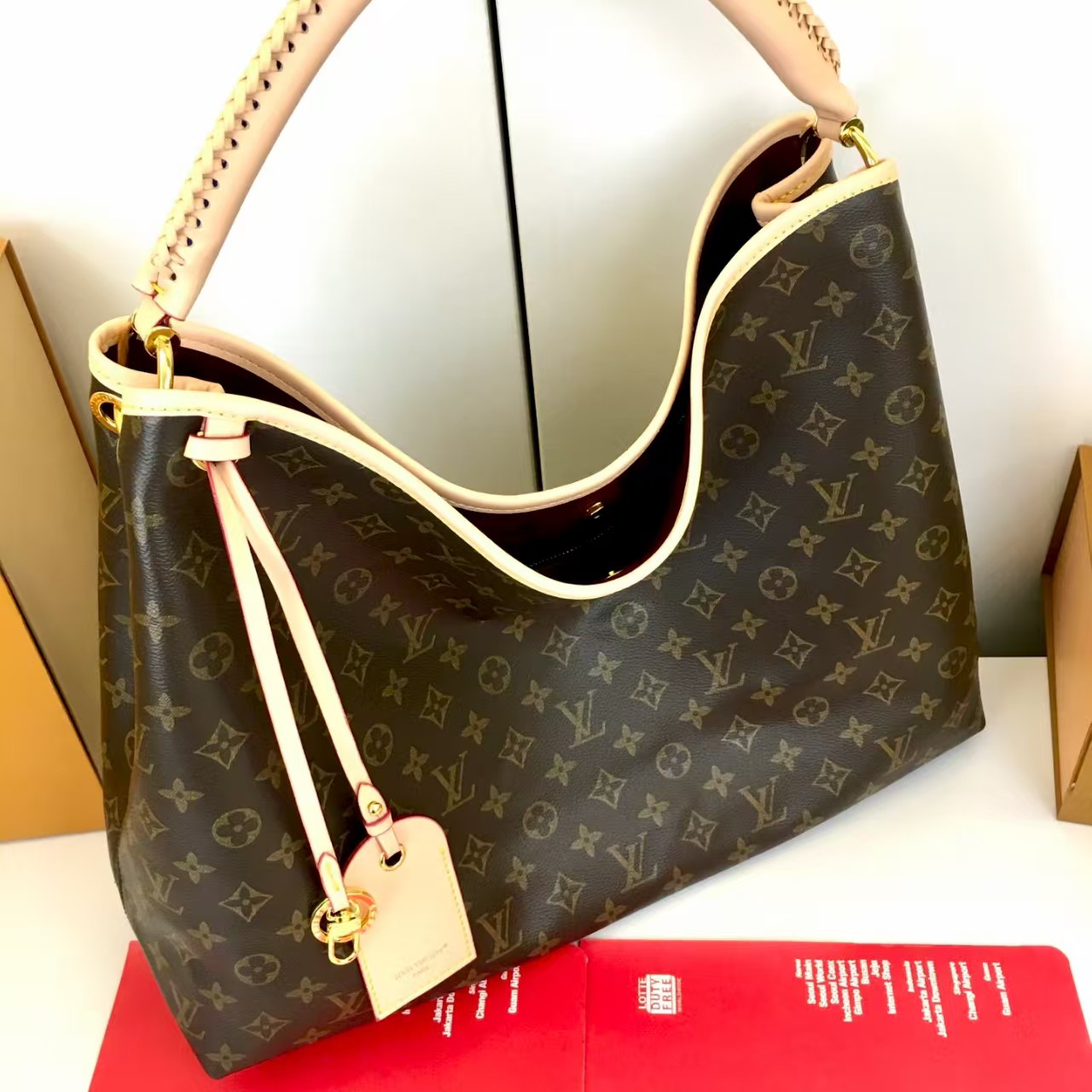 LV again artsy monogram handbag
