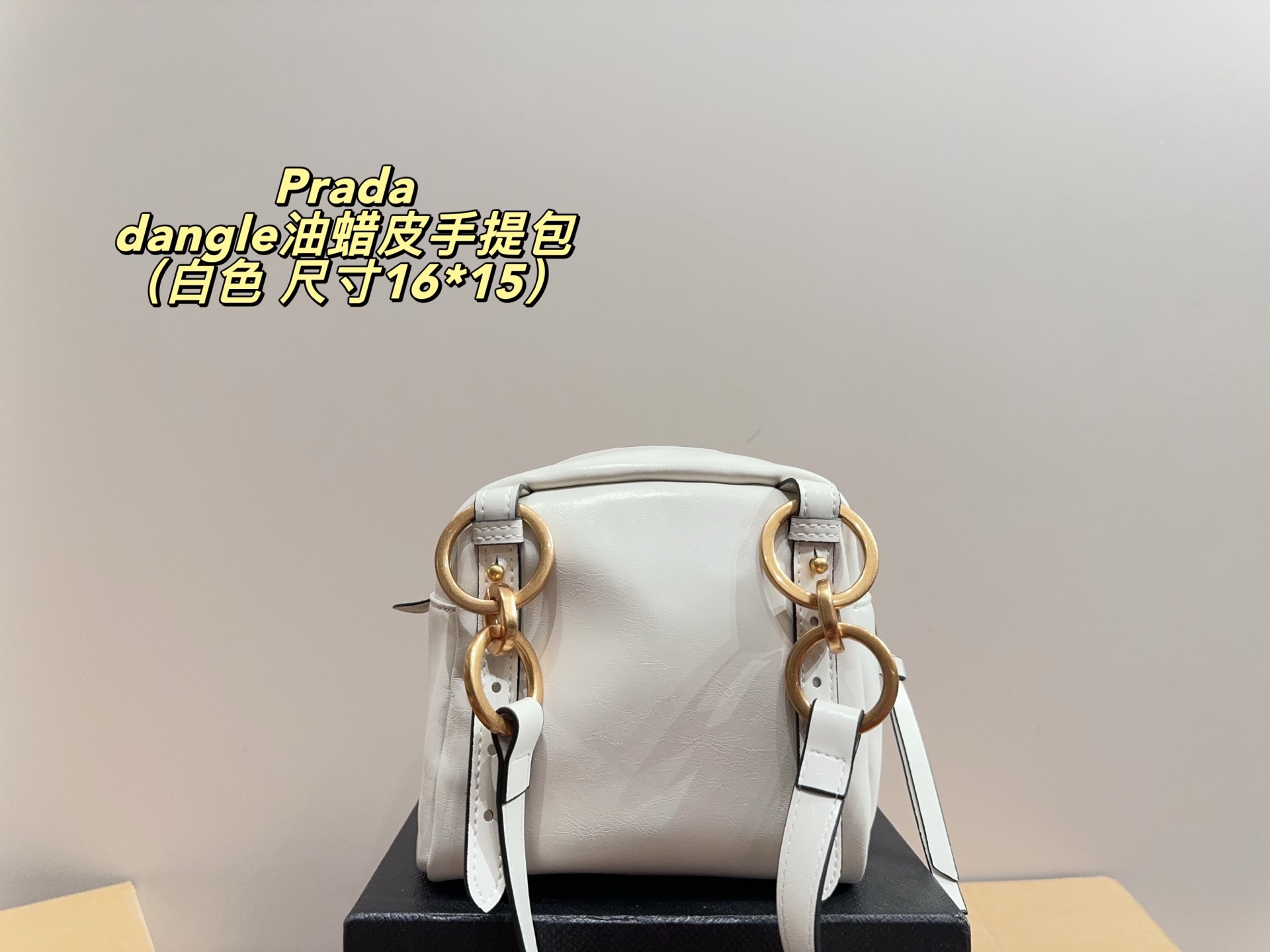 Prada dangle mini oil-wax leather handbag