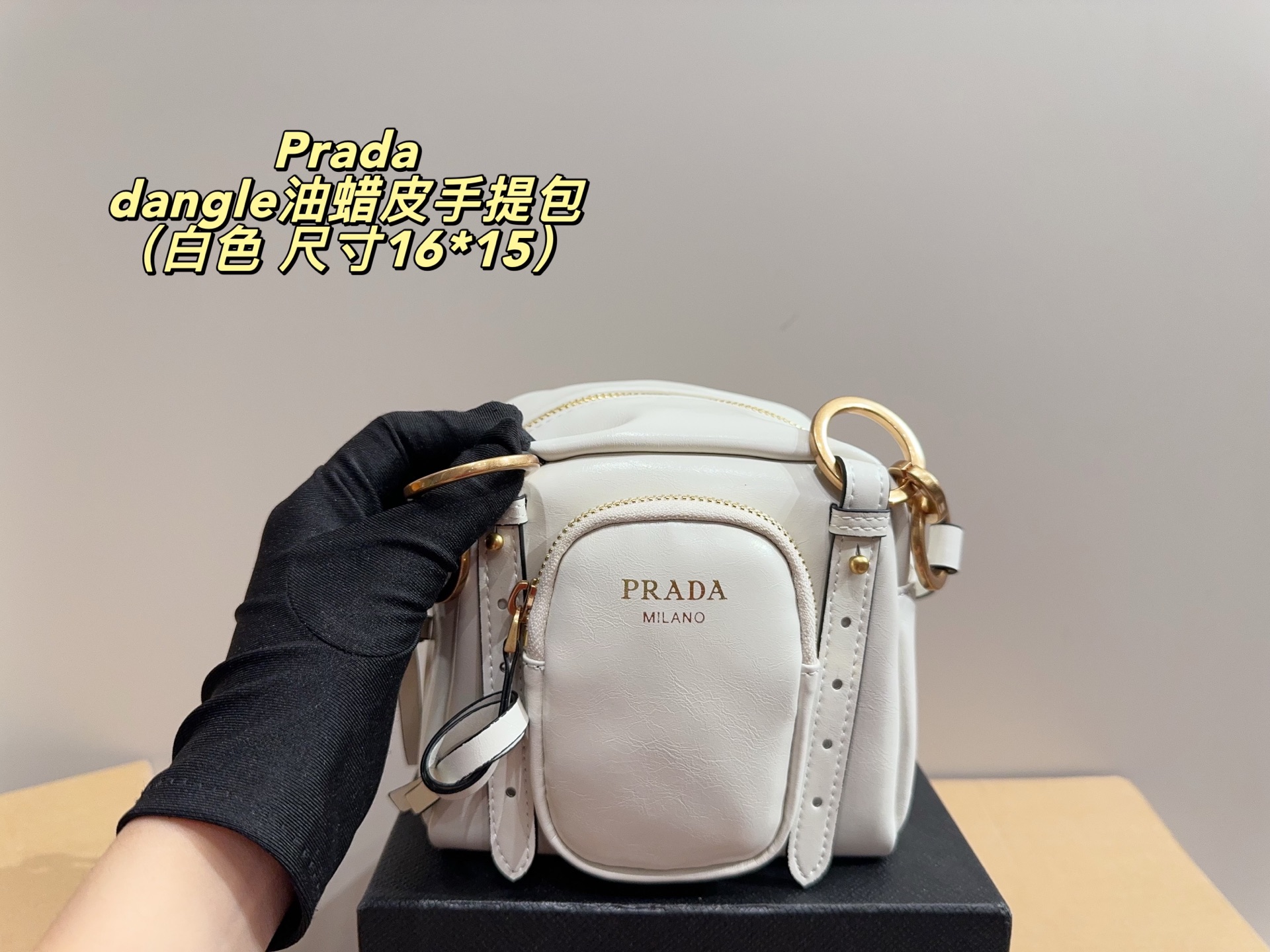 Prada dangle mini oil-wax leather handbag