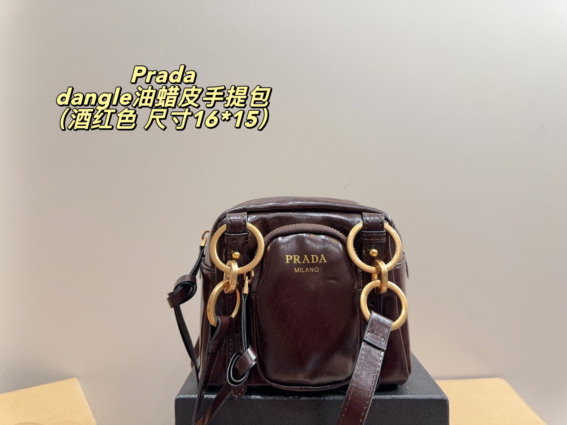 Prada dangle mini oil-wax leather handbag