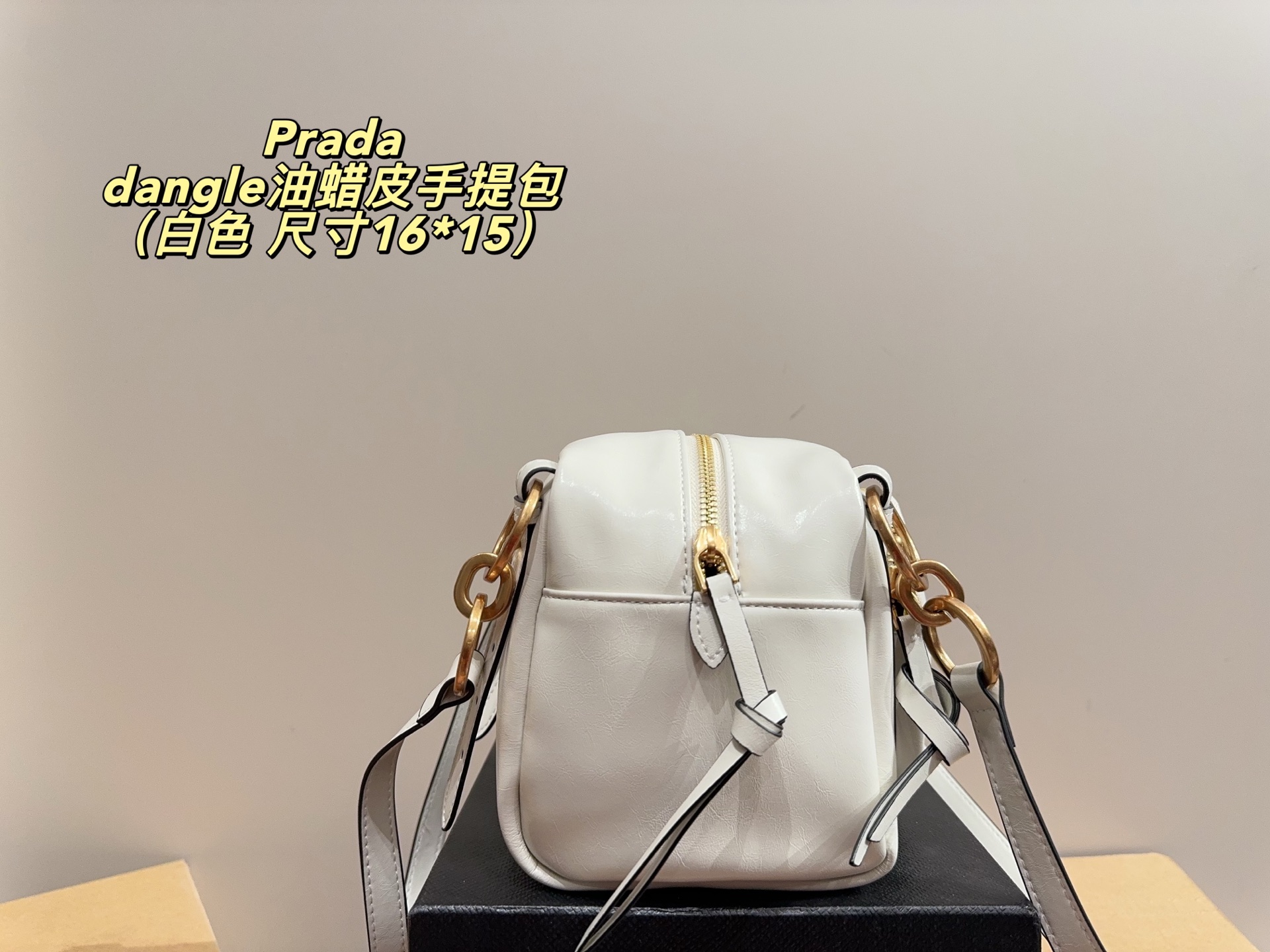 Prada dangle mini oil-wax leather handbag